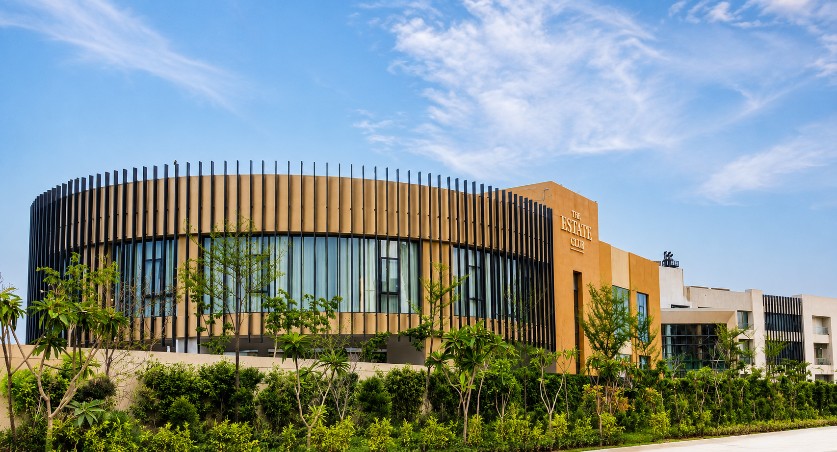 The Estate Club circular clubhouse with vertical fin facade in Gurugram