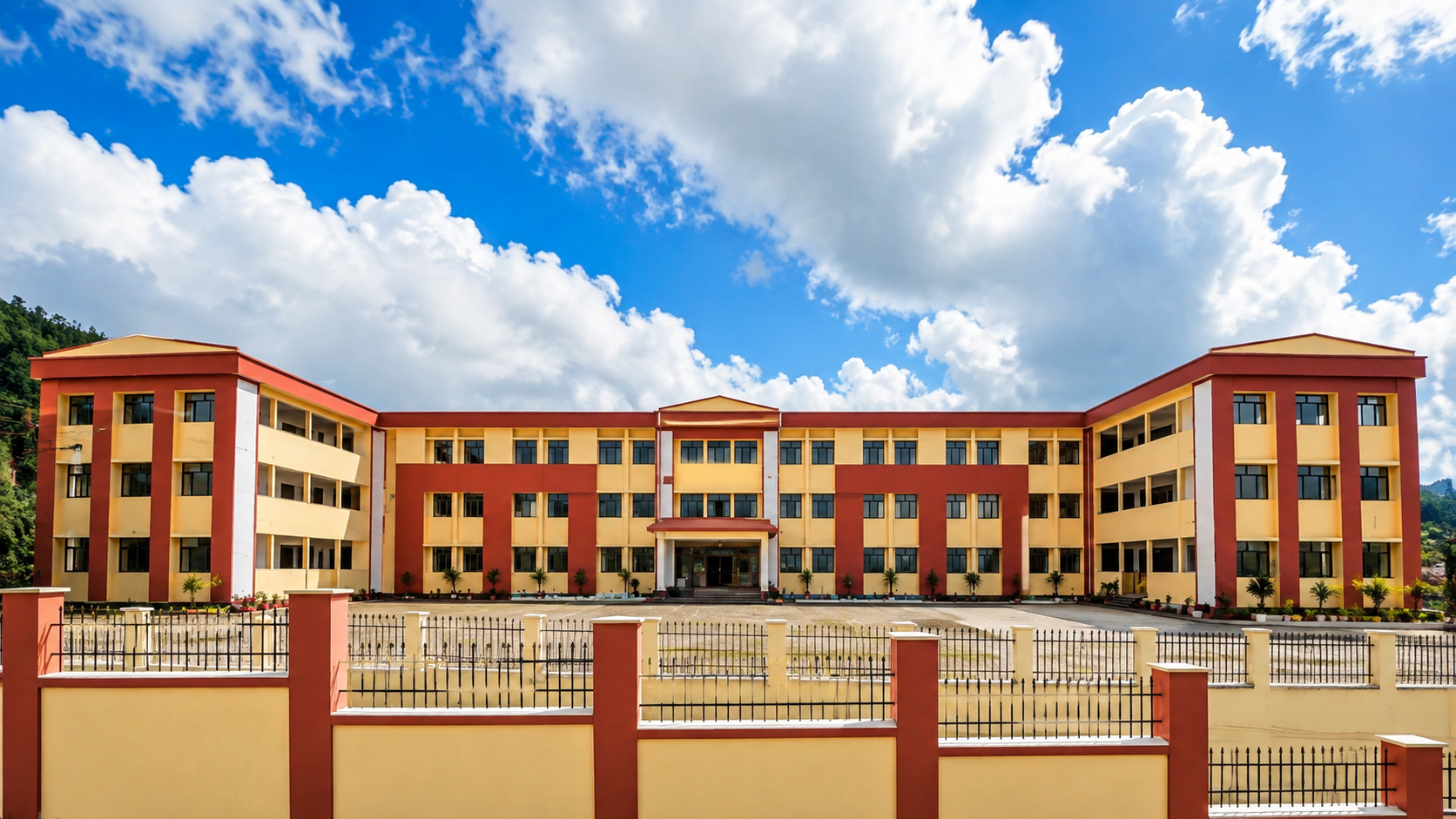 Completed Kendriya Vidyalaya school building with red and cream facade against a Himalayan sky
