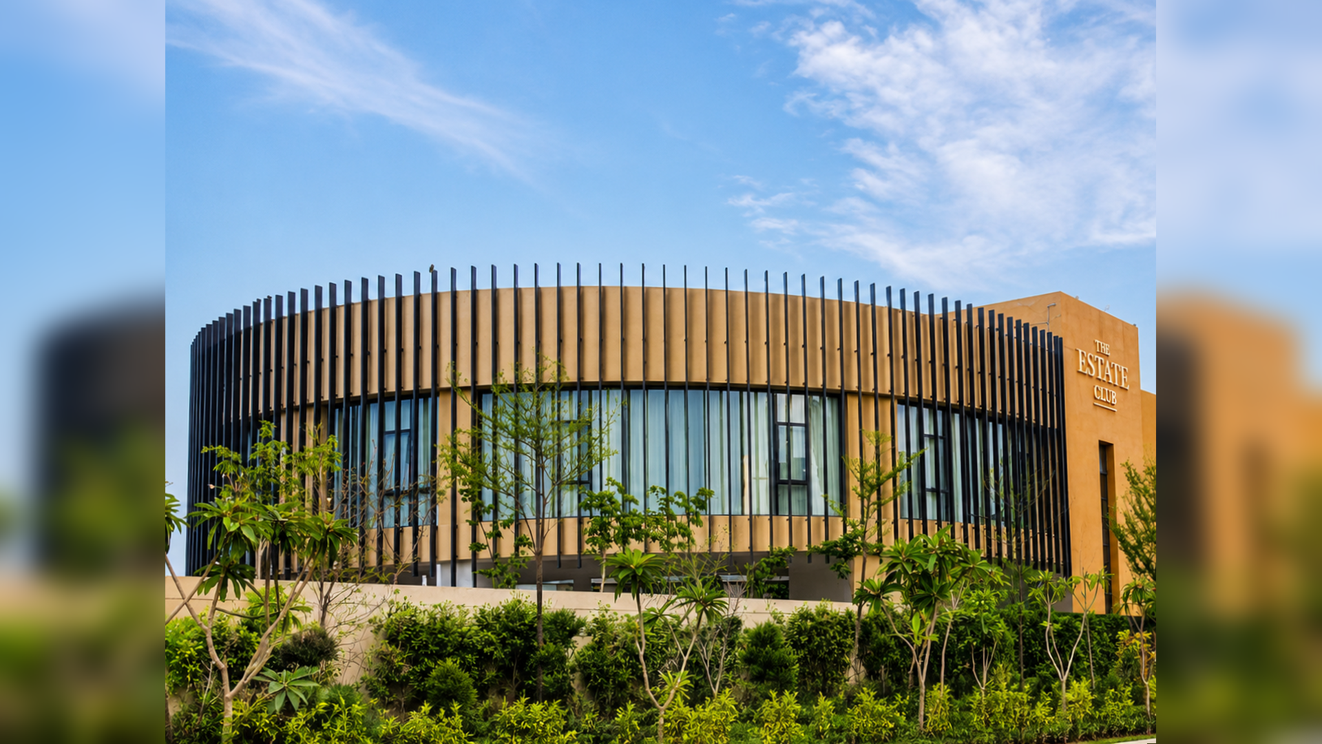 Modern hospitality club building with circular facade and landscaped entrance