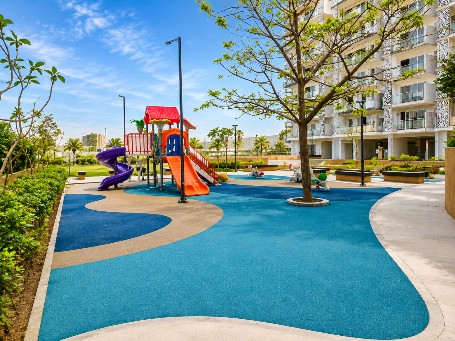 Children's play area with coloured sports flooring and paved walkways at Godrej Golflink