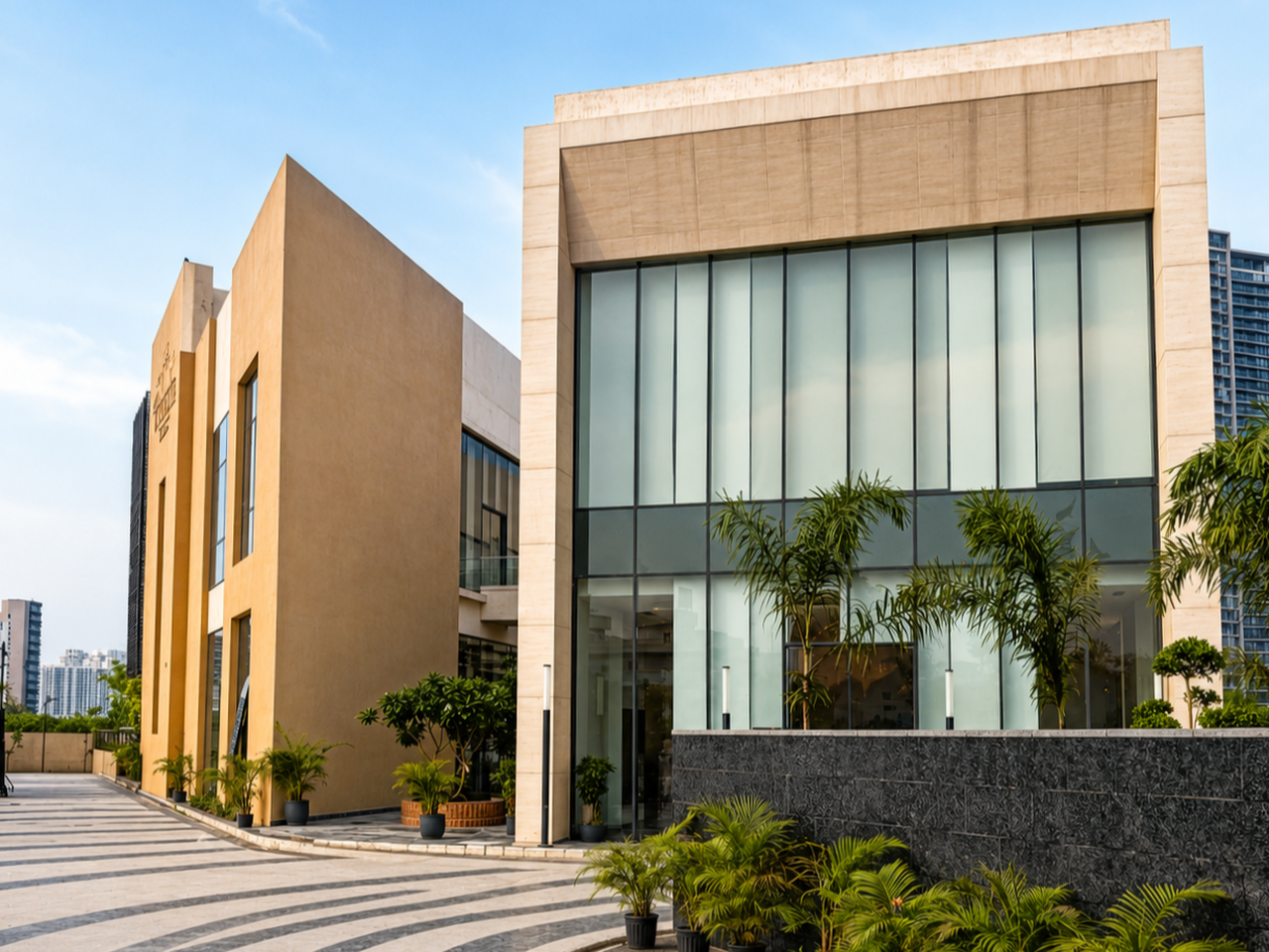 Estate Club entrance plaza with stone facade and patterned hardscape