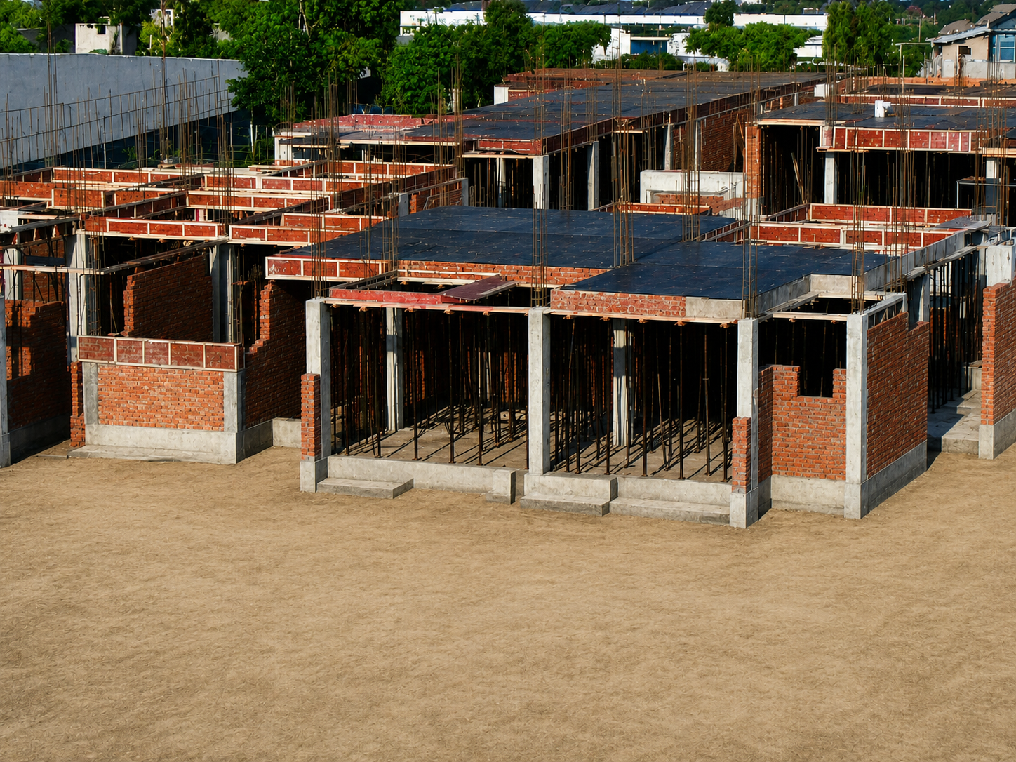 Ground-floor slab shuttering and masonry across the residential units
